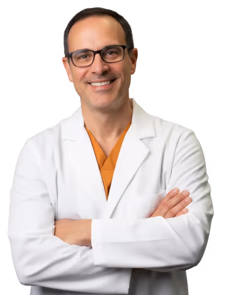 Smiling physician in a white lab coat, representing personalized care in peptide therapy and metabolic health optimization.